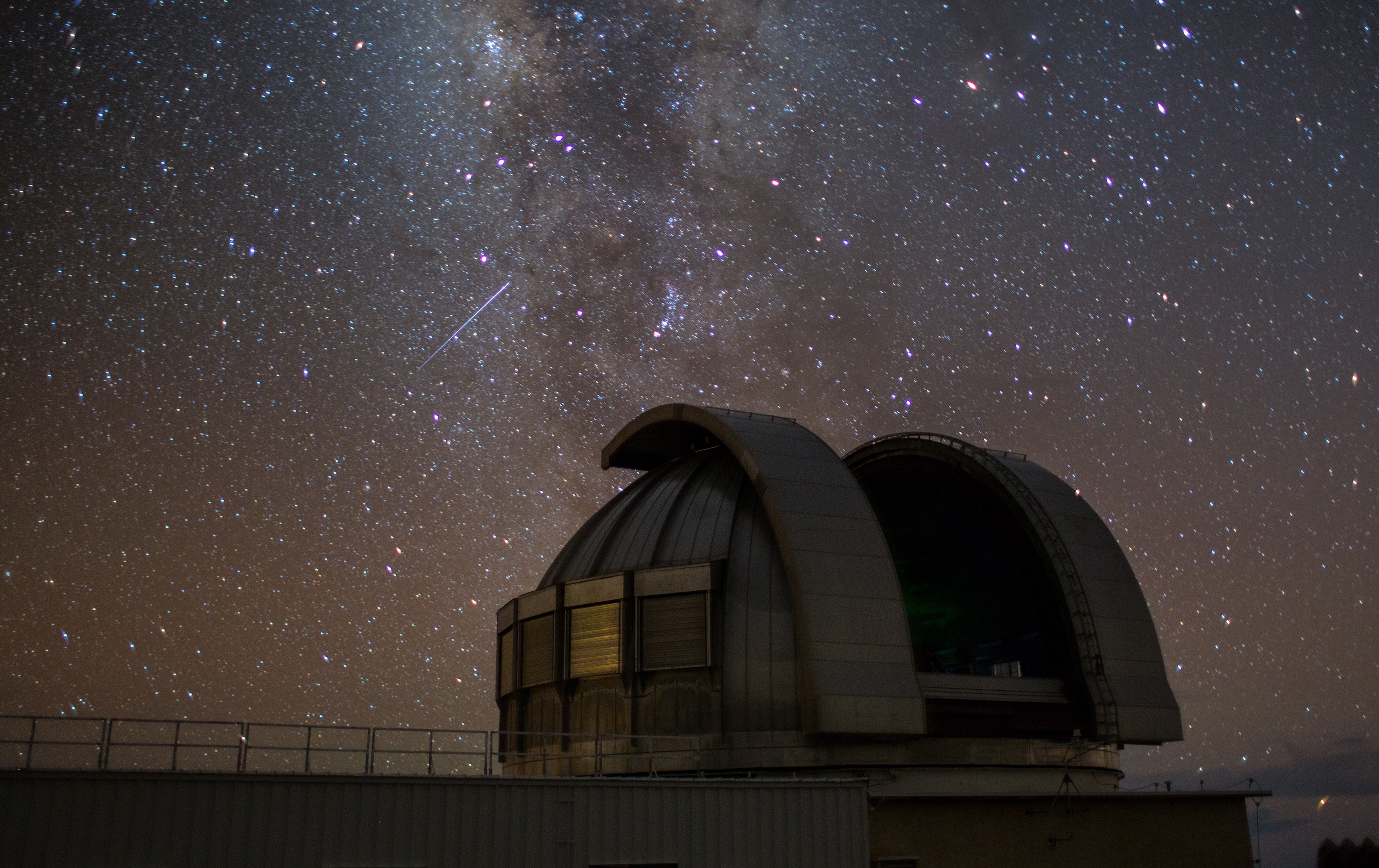 An observatory at night with stars