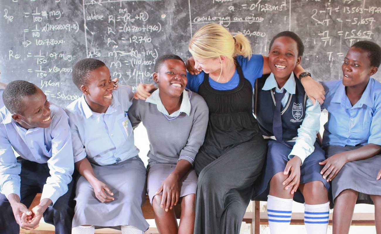 Rural Widows Orphan AIDS Network Woman laughing with students