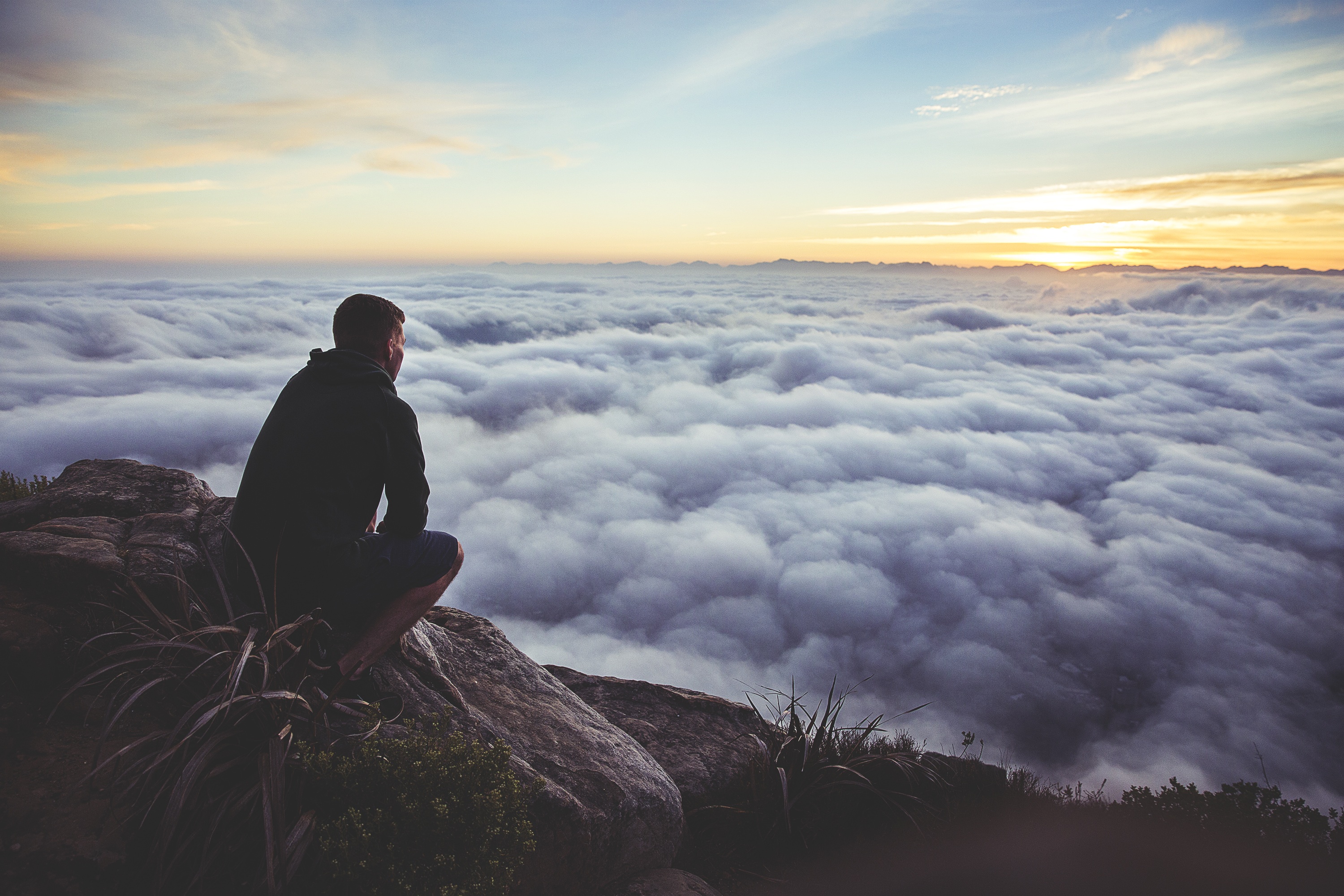 Man looking down at the clouds